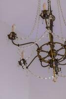 Close up shot of the decorative walls, ceiling and chandelier. Interior photo