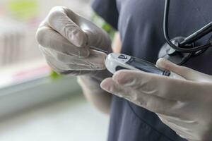 Close up shot of the nurse holding glucometer instrument. Healthcare photo