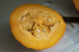 Close up shot of the cut pumpkin on the table. Vegetable photo