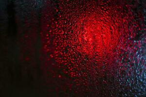 Shot of the window with blurred lights on the background and condensation. Background photo