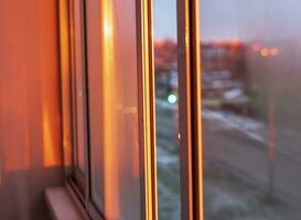 Shot of the sun setting and reflecting in the window. Concept photo