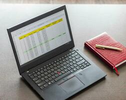 Laptop showing an excel sheet on the screen with bank loan amortization table. Finance photo