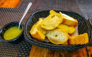 Bread in basket and green coriander sauce restaurant Mexico. photo