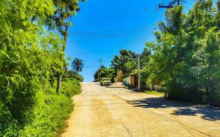 Typical beautiful colorful tourist street sidewalk city Puerto Escondido Mexico. photo