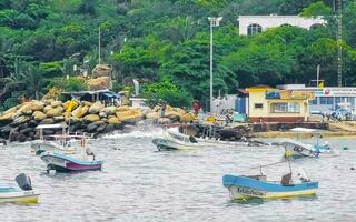 Puerto Escondido Oaxaca Mexico 2022 Fishing boats at the harbor beach in Puerto Escondido Mexico. photo