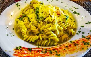 White plate of tasty pasta noodles meal dish food Mexico. photo