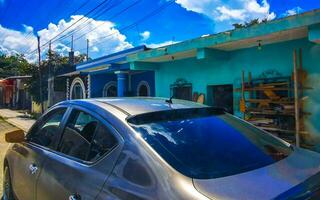 Typical colorful street road traffic cars palms of Tulum Mexico. photo