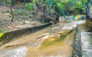 Puerto Escondido Oaxaca Mexico 2022 Open sewerage system in the tropical jungle mountains Mexico. photo