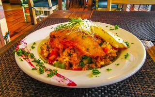 A la parrilla pescado en arroz vegetales y chipotle salsa plato comida. foto