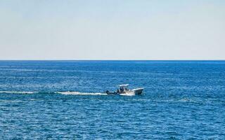 Fishing boats at the harbor beach in Puerto Escondido Mexico. photo