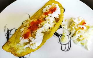 Mexican empanada on white plate from Playa del Carmen Mexico. photo