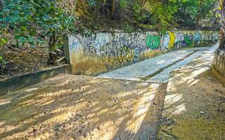 Puerto Escondido Oaxaca Mexico 2022 Open sewerage system in the tropical jungle mountains Mexico. photo