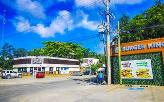 Tulum Quintan Roo Mexico 2023 Typical colorful street road traffic cars palms of Tulum Mexico. photo