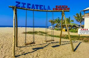 Puerto Escondido Oaxaca Mexico 2023 Romantic paradise swing on the beach in Puerto Escondido Mexico. photo