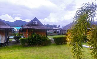 Wooden bamboo cottages in natural tropical jungle resort Krabi Thailand. photo