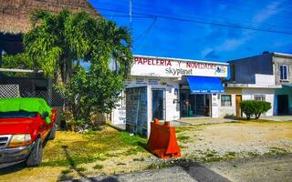 Tulum Quintan Roo Mexico 2023 Typical colorful street road traffic cars palms of Tulum Mexico. photo