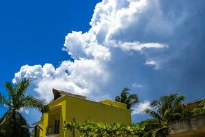 Modern buildings architecture hotels apartments palm Playa del Carmen Mexico. photo