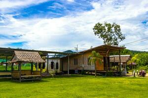 Wooden bamboo cottages in natural tropical jungle resort Krabi Thailand. photo