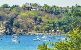 Fishing boats at the harbor beach in Puerto Escondido Mexico. photo