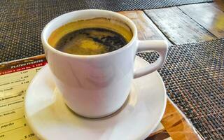 Cup of americano black coffee in restaurant cafe in Mexico. photo