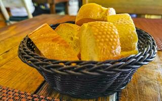 Bread in basket on wooden table vintage restaurant Mexico. photo