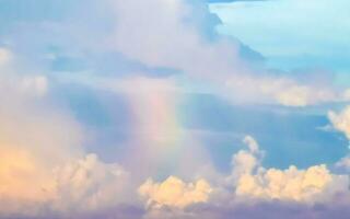 Beautiful and rare rainbow in cloudy sky blue background Mexico. photo