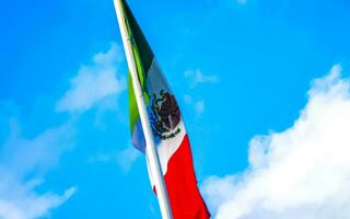 Mexican green white red flag with blue sky in Mexico. photo