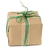 The box is packed in brown craft paper and tied with a rope on a white background photo