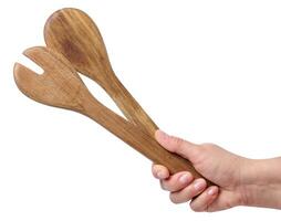 A woman's hand holds a wooden spoon on a white background photo
