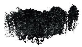 Swatch of black smudged acrylic paint isolated on white background photo