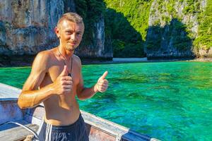 Tourist on Koh Phi Phi island Thailand with longtail boats. photo