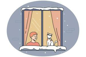 Smiling boy and cat in window during winter vector