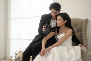 Groom taking pictures of beautiful bride for wedding ceremony, Love ,Romantic and wedding proposal concept. photo