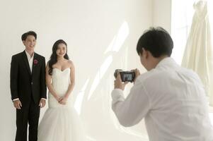 Photographer taking pictures of bride and groom in wedding ceremony, Love ,Romantic and wedding proposal concept. photo