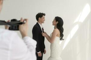 Photographer taking pictures of bride and groom in wedding ceremony, Love ,Romantic and wedding proposal concept. photo
