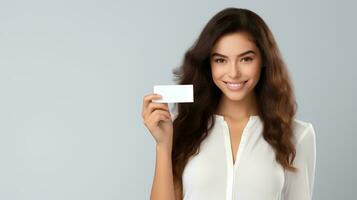 AI generated Cheerful beautiful young businesswoman holding plain business card for mockup material, plain card without text, studio photo, isolated white background photo