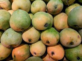 background of piles of mangoes photo