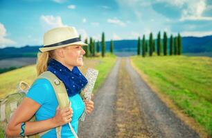 Cute female trekking along Europe photo