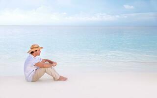 Thoughtful man on the beach photo