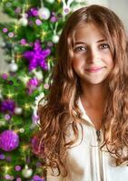 Sweet girl portrait near Christmas tree photo