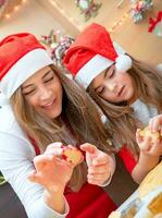 Mother and daughter doing Christmas sweets photo