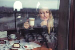 Pretty woman drinking latte photo