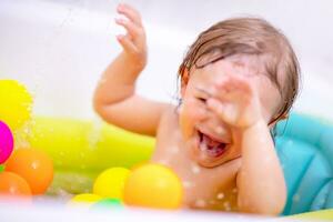 Cheerful baby taking bath photo