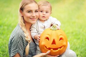 Happy family with Halloween pumpkin photo