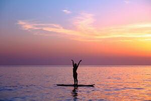 Doing yoga asanas on the beach photo