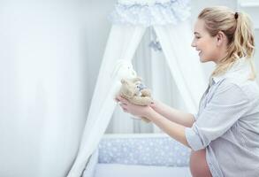 Happy mother prepares child's room photo