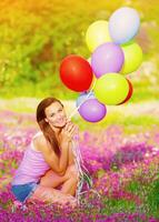 Pretty girl holding colorful balloons photo