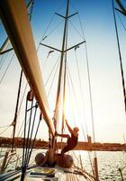 Young sailor on sailboat photo