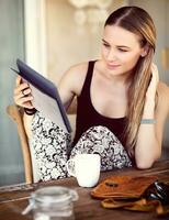 Woman having breakfast in a city cafe photo