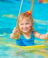 Happy girl on water swing photo